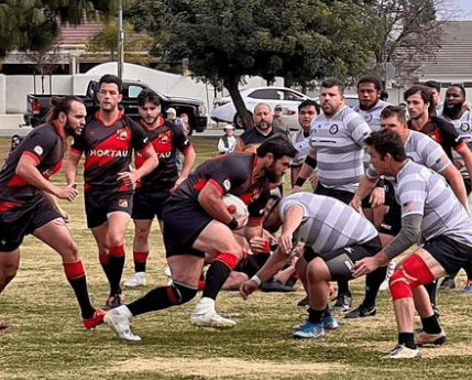 Rugby Player playing a game about to tackle another player with their strength and power